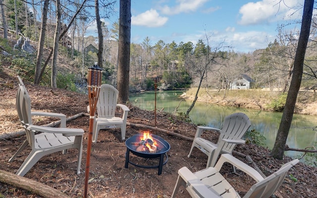 view of patio / terrace with a water view and an outdoor fire pit