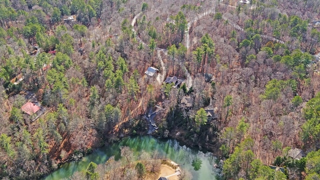 birds eye view of property with a view of trees