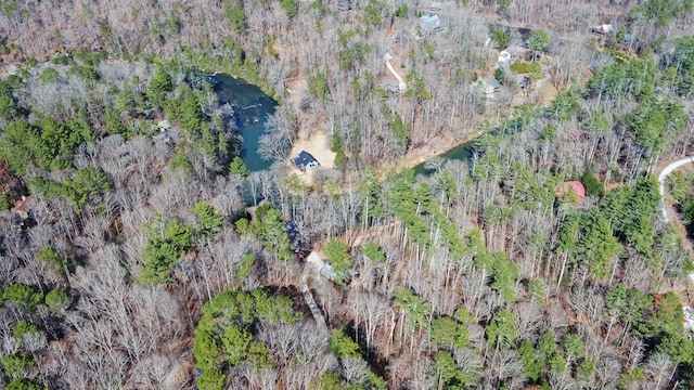 birds eye view of property featuring a wooded view