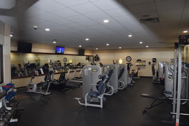 gym featuring a paneled ceiling and visible vents