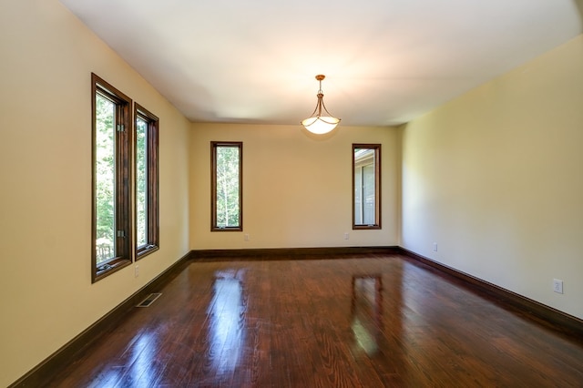 unfurnished room featuring wood finished floors and baseboards