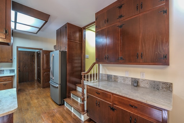 kitchen featuring freestanding refrigerator, dark wood-style floors, and light countertops