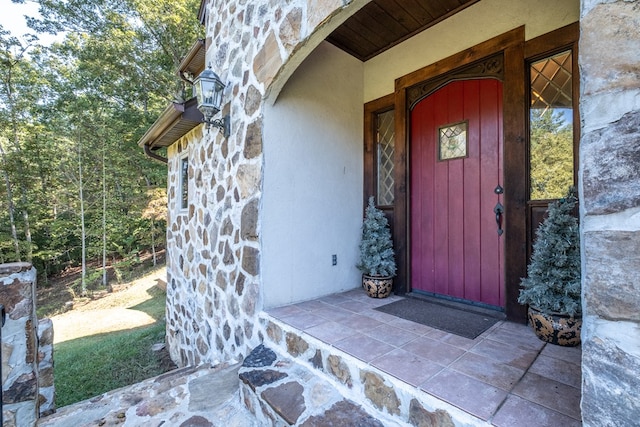 doorway to property with stone siding