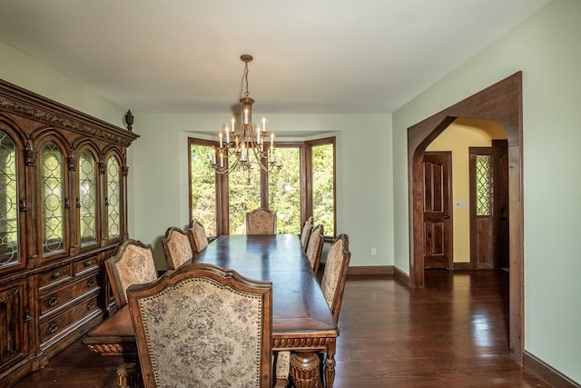 dining area with a chandelier, plenty of natural light, dark wood-style floors, and baseboards
