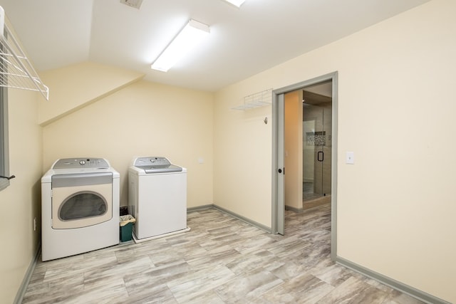 laundry room featuring separate washer and dryer and baseboards