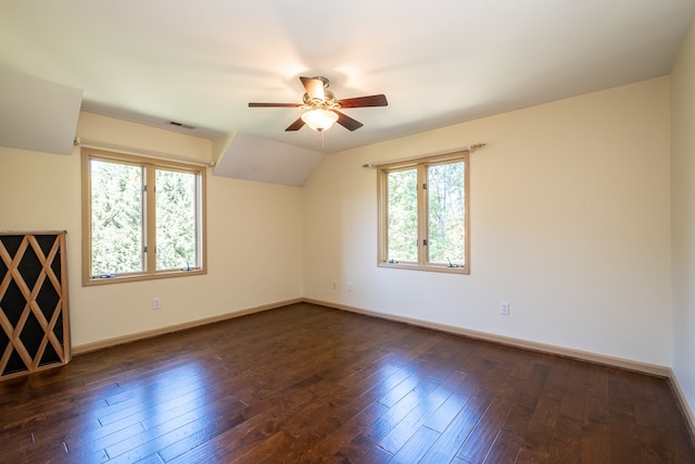 additional living space with a ceiling fan, baseboards, dark wood-style flooring, and lofted ceiling