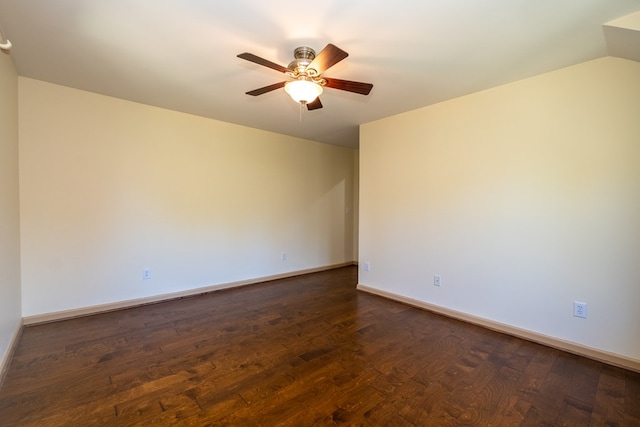 unfurnished room with a ceiling fan, dark wood-style floors, and baseboards