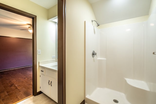 bathroom with a shower, a ceiling fan, and vanity