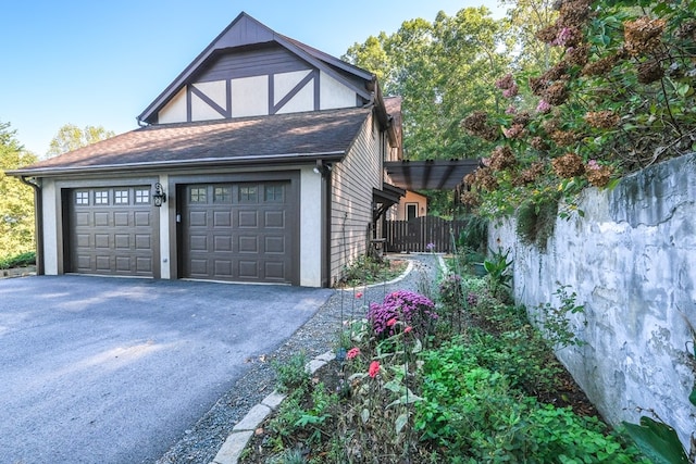 view of side of property with a garage and driveway