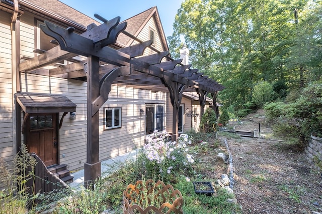 view of property exterior with a pergola and roof with shingles