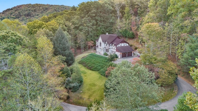 aerial view of property and surrounding area with a forest