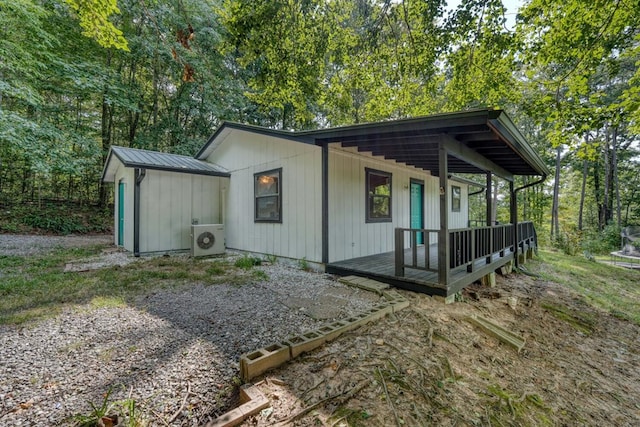 exterior space with ac unit and a porch