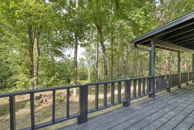 wooden deck with a forest view