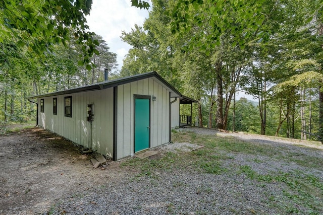 view of outbuilding featuring driveway and an outdoor structure