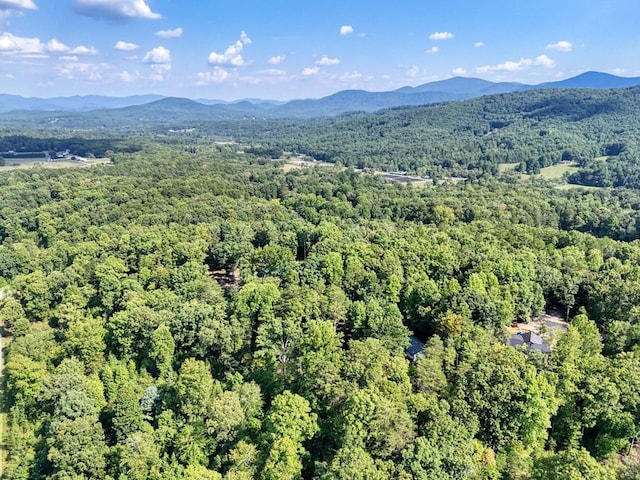 birds eye view of property with a mountain view and a forest view