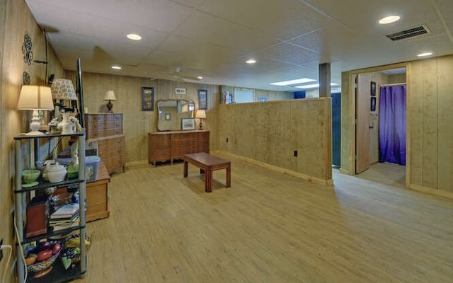 interior space with wooden walls, visible vents, light wood finished floors, recessed lighting, and a paneled ceiling