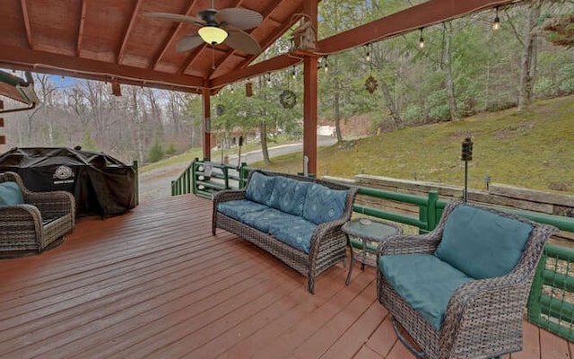 wooden terrace featuring a yard, area for grilling, an outdoor hangout area, and a ceiling fan