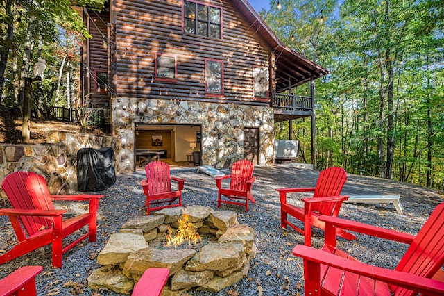 view of patio / terrace featuring a balcony and an outdoor fire pit