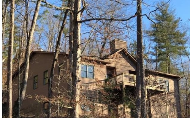 view of side of home featuring a balcony