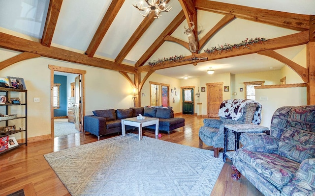 living room featuring a notable chandelier, light hardwood / wood-style floors, and plenty of natural light