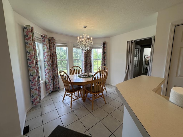 3273 Ivy Log Rd, Blairsville, GA 30512 - dining space featuring a chandelier, light tile patterned floors, a textured ceiling, and baseboards