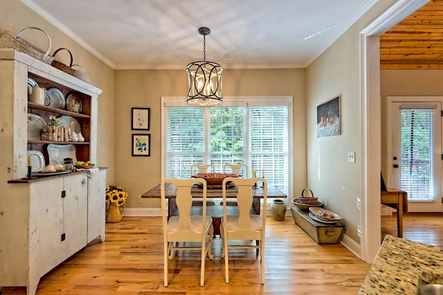 dining room with ornamental molding, a chandelier, and light wood-type flooring