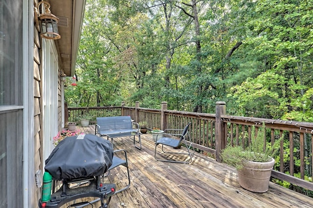 wooden deck featuring a grill