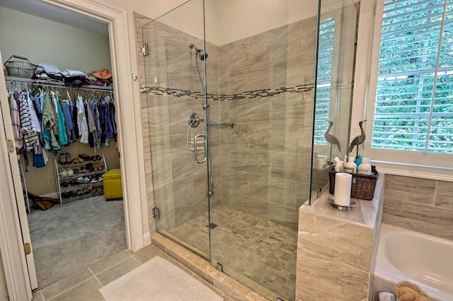 10 Quiet Place Ln, Clayton, GA 30525 - full bathroom with a stall shower, tile patterned floors, a bath, and a walk in closet