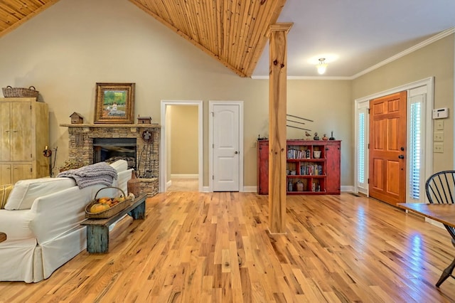 living room with a stone fireplace, wood ceiling, light hardwood / wood-style flooring, crown molding, and high vaulted ceiling