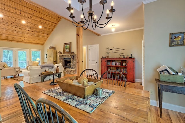10 Quiet Place Ln, Clayton, GA 30525 - dining area with a brick fireplace, a chandelier, wood finished floors, baseboards, and high vaulted ceiling