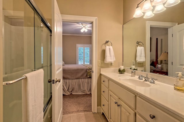 bathroom featuring a shower with door, ceiling fan, tile patterned floors, vanity, and ornamental molding