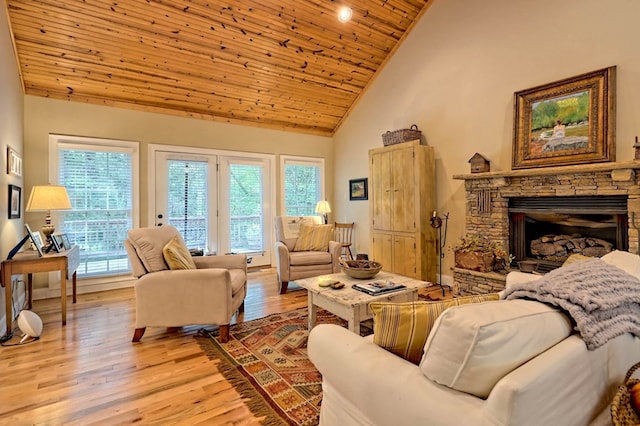 living room with wood ceiling, high vaulted ceiling, light hardwood / wood-style flooring, and plenty of natural light