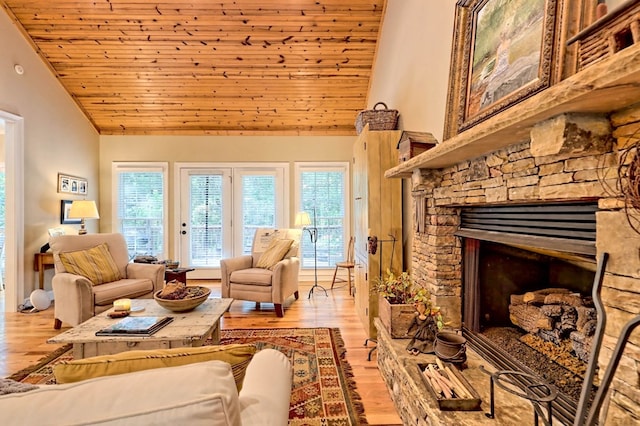 living room featuring high vaulted ceiling, a fireplace, light wood-type flooring, and wooden ceiling