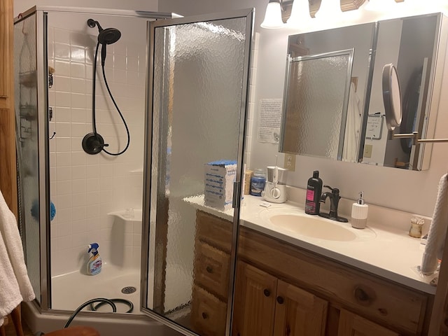 bathroom with vanity and a shower with shower door