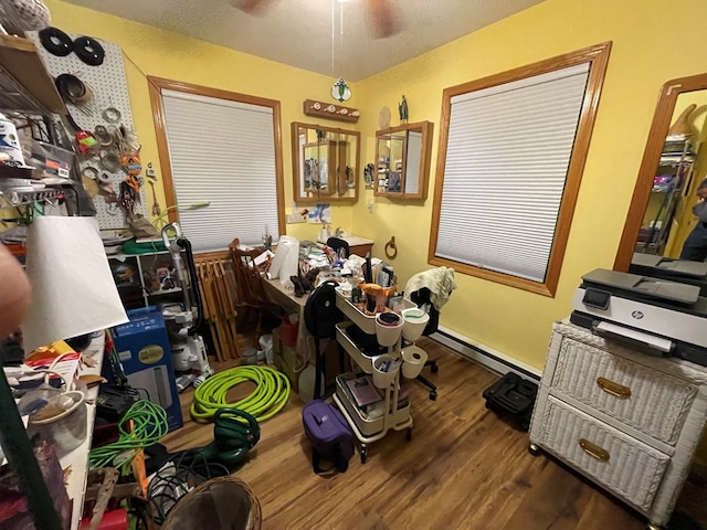 miscellaneous room featuring ceiling fan, dark hardwood / wood-style floors, and a baseboard radiator