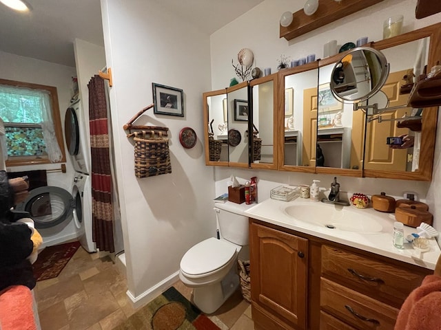 bathroom with a shower with curtain, vanity, toilet, and stacked washer / drying machine