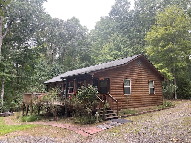 log home featuring a wooden deck