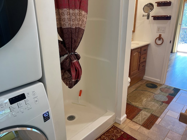 352 Partridge Ln, Murphy, NC 28906 - bathroom with estacked washer and dryer, a shower stall, vanity, tile patterned floors, and baseboards