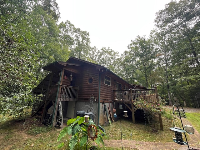 view of property exterior featuring a wooden deck