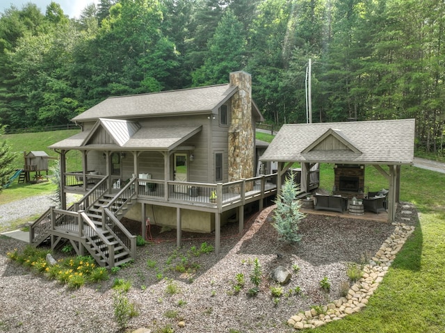 view of front of home with a front yard, a gazebo, and a deck