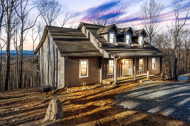 cape cod-style house featuring covered porch