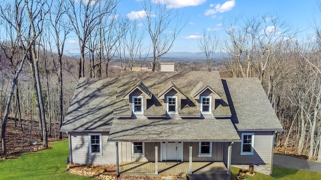 cape cod home with a porch, roof with shingles, and a front lawn