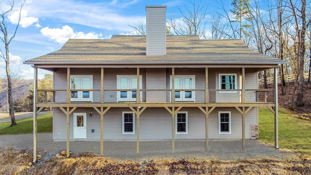 back of property featuring french doors, a balcony, and a patio area