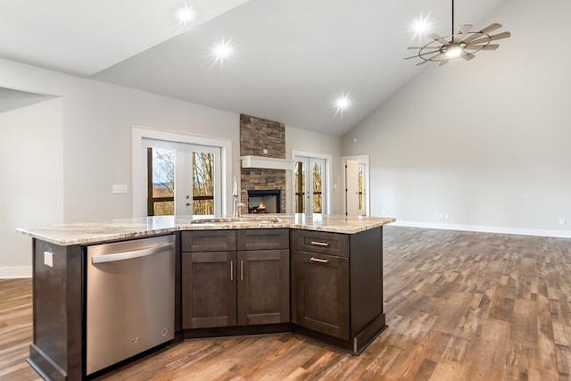 kitchen featuring stainless steel dishwasher, wood-type flooring, sink, and dark brown cabinets