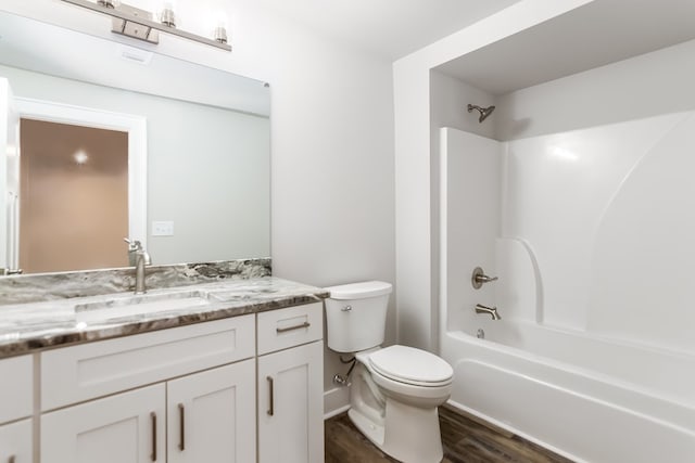 full bathroom featuring visible vents, toilet, wood finished floors, tub / shower combination, and vanity