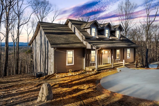 cape cod house featuring covered porch