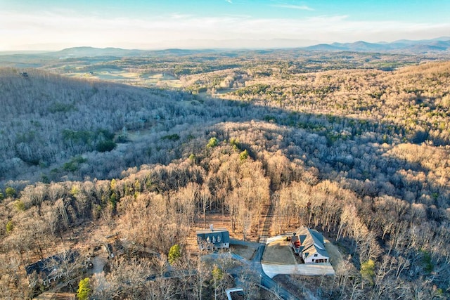 aerial view with a mountain view and a wooded view