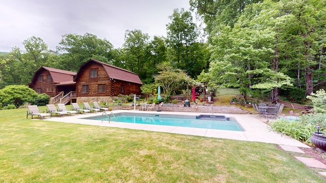 view of pool featuring a patio area and a yard