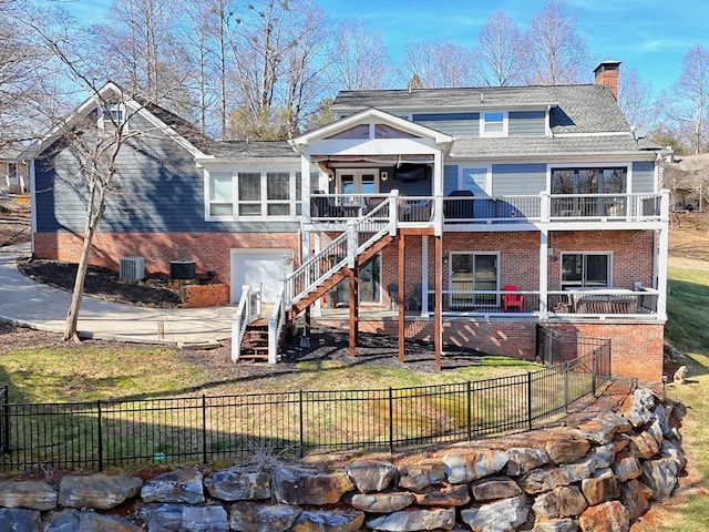 view of front facade with a garage, a front lawn, and a balcony