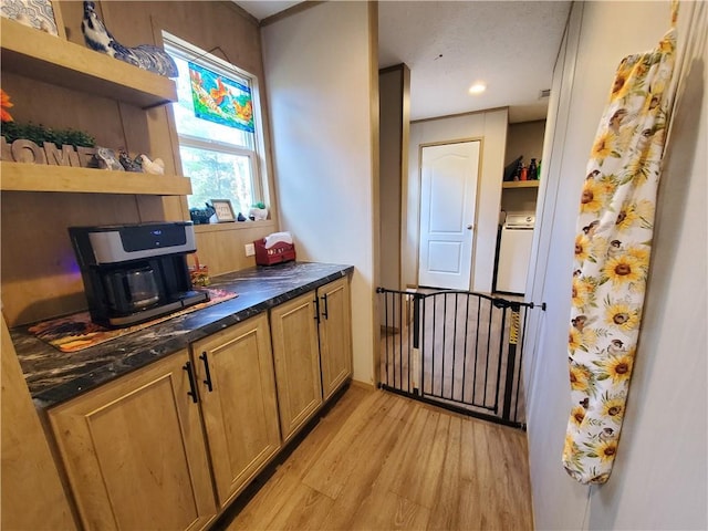 kitchen with light hardwood / wood-style floors and washer / clothes dryer